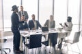 Serious Indian CEO in interacting with multiracial vendors at corporate meeting Royalty Free Stock Photo