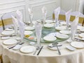 Elegant white banquet round dinner table in wedding hall