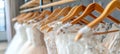 Elegant white bridal gowns on hangers in a luxurious boutique salon, perfect for weddings