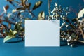 Elegant white business card onblue background with plant