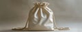 Elegant white drawstring bag on gray backdrop Royalty Free Stock Photo
