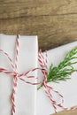 Elegant White Gift Boxes Tied with Red Ribbon Green Juniper Twig Stacked on Wood Tabletop Background. Christmas New Years Presents Royalty Free Stock Photo