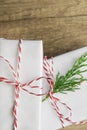 Elegant White Gift Boxes Tied with Red Ribbon Green Juniper Twig Stacked on Wood Tabletop Background. Christmas New Years Presents