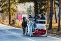 Elegant white horse carriage transportantion on the mountains roads in winter season. Moroeni, Romania, 2020 Royalty Free Stock Photo