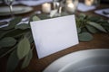 Elegant White Name Card on Eucalyptus Wedding Table. Perfect for Place Settings. Royalty Free Stock Photo