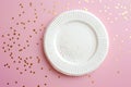 Elegant White Paper Plate Mockup with Gold Confetti on Pink Background for Celebrations. Royalty Free Stock Photo