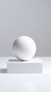 Elegant white sphere on a sleek white block against a bright neutral background Royalty Free Stock Photo