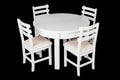 Elegant white table and chairs with clipping path. White table and chairs isolated on a black background. A set of furniture for Royalty Free Stock Photo