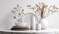 Elegant White Tableware And Decorative Vase With Dried Grass On Marble Surface Against Textured White Wall In Stylish Interior Royalty Free Stock Photo