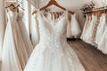 Elegant white wedding dresses hanging on hangers in a luxurious bridal boutique salon Royalty Free Stock Photo