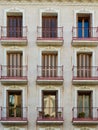 Elegant windows on vintage authentic building of beige colours. Old-fashioned historical buildings in Zaragoza, Aragon, Spain.