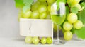 Elegant Wine Card Design: Sweet Green Grapes and a Glass of Wine Background.