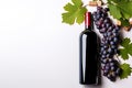 Elegant Wine Delight Bottle of Red Wine with Ripe Grapes and Vine Leaves on Crisp White Background. created with Generative AI Royalty Free Stock Photo