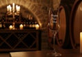 Elegant Wine Glass in Candlelit Cellar Setting Royalty Free Stock Photo