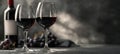 The elegant wine glasses with red wine next to a bottle and grapes. AI generated image Royalty Free Stock Photo