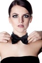 Elegant woman adjusting bow tie