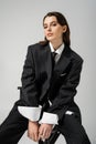 elegant woman in black oversize suit
