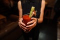 Woman holding a glass of alcoholic cocktail Bloody Mary indoors Royalty Free Stock Photo