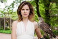 Elegant woman brunette with hawk bird outdoor portrait