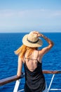 Elegant woman with casual dress and hat on a ferry boat on the Aegean sea, Cyclades, Greece Royalty Free Stock Photo