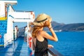 Elegant woman with casual dress and hat on a ferry boat on the Aegean sea, Cyclades, Greece Royalty Free Stock Photo