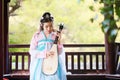 Elegant woman in Chinese traditional drama ancient costume play Chinese lute pipa guitar Royalty Free Stock Photo