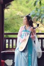 Elegant woman in Chinese traditional drama ancient costume play Chinese lute pipa guitar Royalty Free Stock Photo