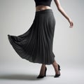 Elegant Woman Dancing In Black Pleated Skirt - Subtle Monochromatic Tones