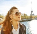 Elegant woman on embankment in Paris looking into the distance Royalty Free Stock Photo