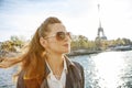 Elegant woman on embankment in Paris looking into the distance Royalty Free Stock Photo