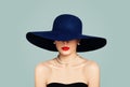 Elegant woman fashion model with red lips makeup wearing classic hat and white pearls, portrait Royalty Free Stock Photo