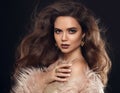 Elegant woman in fur coat. Beautiful girl with long wavy hair st Royalty Free Stock Photo