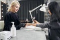 Elegant woman getting nail hygiene in nail salon