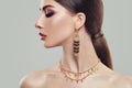 Elegant Woman with Gold Jewelry Earrings and Chain