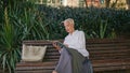 Elegant woman holding book enjoying time alone. Thoughtful stylish pensioner Royalty Free Stock Photo