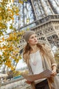 Elegant woman holding map and looking into the distance in Paris Royalty Free Stock Photo