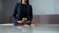 Elegant woman holding money, loan from bank to start own business, crediting