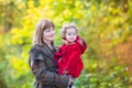 Elegant woman with little toddler girl in autumn park Royalty Free Stock Photo
