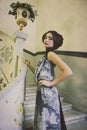 Elegant woman in long dress on vintage stairs