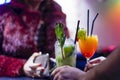 Elegant Woman Pays for Cocktails While Bartender Serving