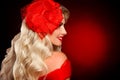 Elegant Woman portrait with red lips and glamour hat isolated on dark studio background. Beautiful girl with curly hair smiling. Royalty Free Stock Photo