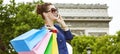 Elegant woman with shopping bags using mobile on Champ Elysees Royalty Free Stock Photo