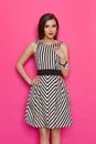 Elegant Woman In Striped Dress Against Pink Background Royalty Free Stock Photo