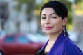 An elegant woman in a stylish outfit poses on a city street Royalty Free Stock Photo