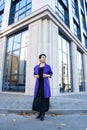 An elegant woman in a stylish outfit poses on a city street Royalty Free Stock Photo