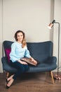 Elegant woman. Successful business woman sitting on stylish sofa. Smiling young female entrepreneur at modern office. Career, free Royalty Free Stock Photo