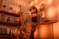 elegant woman in sunglasses holding retro telephone in kitchen Royalty Free Stock Photo