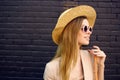 Elegant woman in sunglasses on a street walk urban style brick background