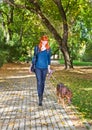 Elegant woman walking her big dog in the park Royalty Free Stock Photo