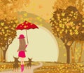 Elegant woman walks her dogs on an autumn day